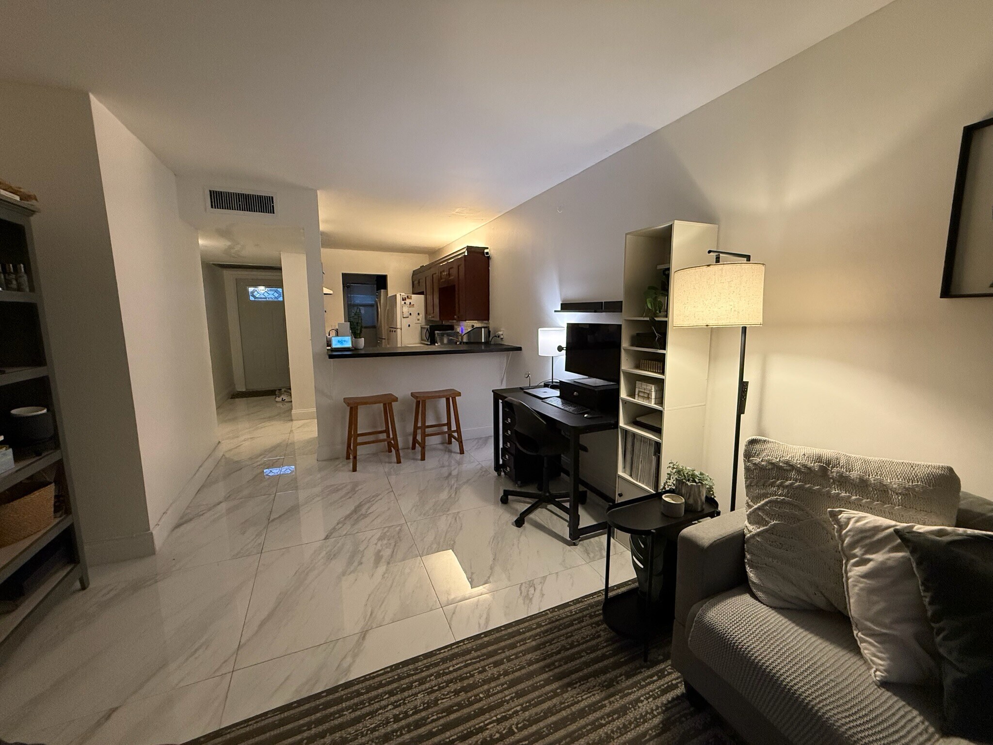 Living area, kitchen, and front door. - 2918 NE 8th Ter