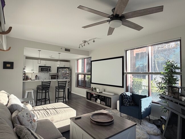 Well lit living room. Versatile custom blinds throughout home to choose any level of privacy. - 1150 J St