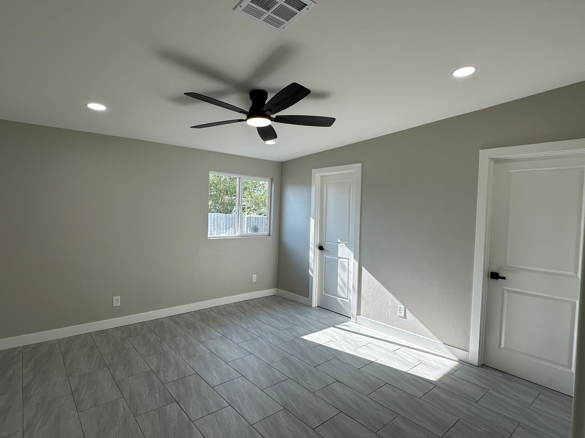 Master bedroom with private master bath and walk-in closet. Designer fans throughout. - 1331 W Speedway Blvd