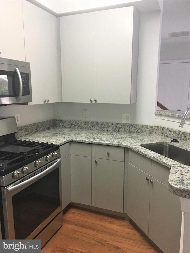 Building Photo - Welcome to this beautifully appointed two level upper condominium that combines modern style with...