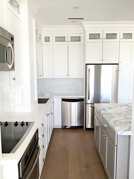 Kitchen w/ Marble & Caesarstone countertops - 10501 Wilshire Blvd