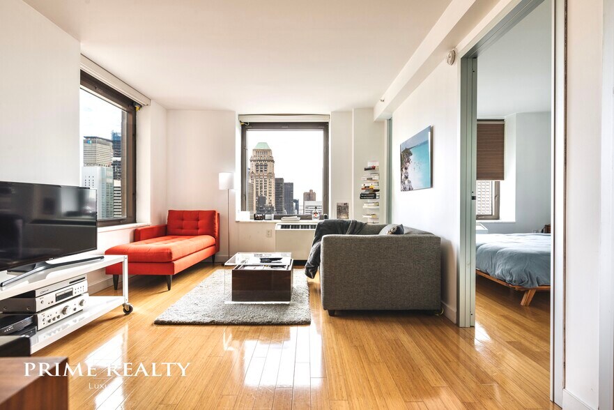 Very large living room, corner unit with high floor views to Bryant Park, East River and a bit of Central Park - 100 W 39th St