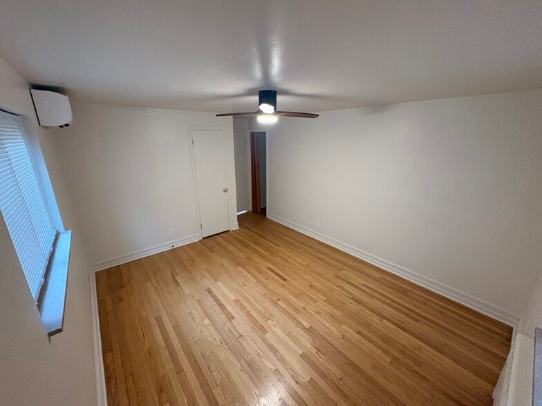 Primary bedroom with hardwood floors - 6035 Oakwood Ave