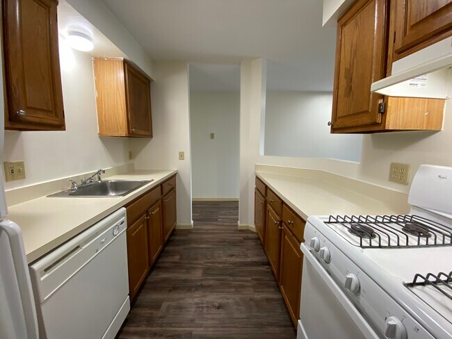 Kitchen with DW & Gas Range - The Landmark Apartments