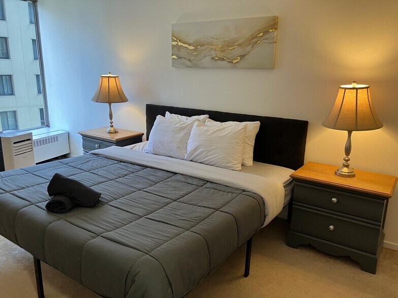 Master Bedroom has a window with river view, king bed with memory foam mattress and a walk-in closet - 8200 E Jefferson Ave