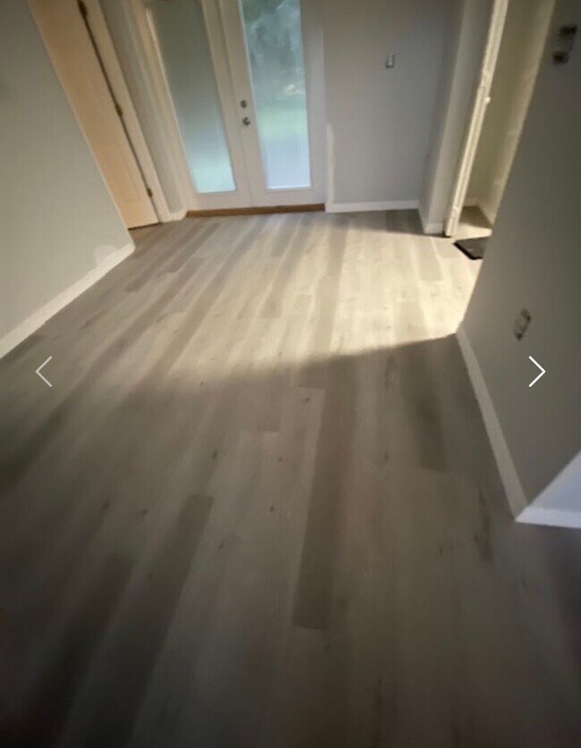 Building Photo - Available NOW! NEW FLOORS AND PAINT! Lovely 3/2 in Poinciana! HUGE fenced yard and NO CARPET!