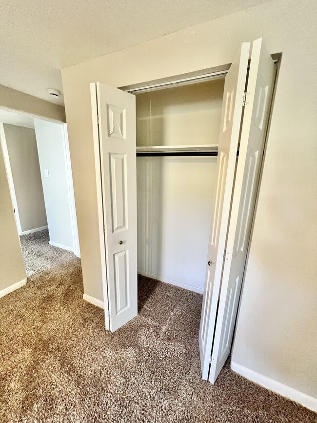 Experience the convenience of ample closet storage in this beautifully carpeted room. - The Kimberly Apartments