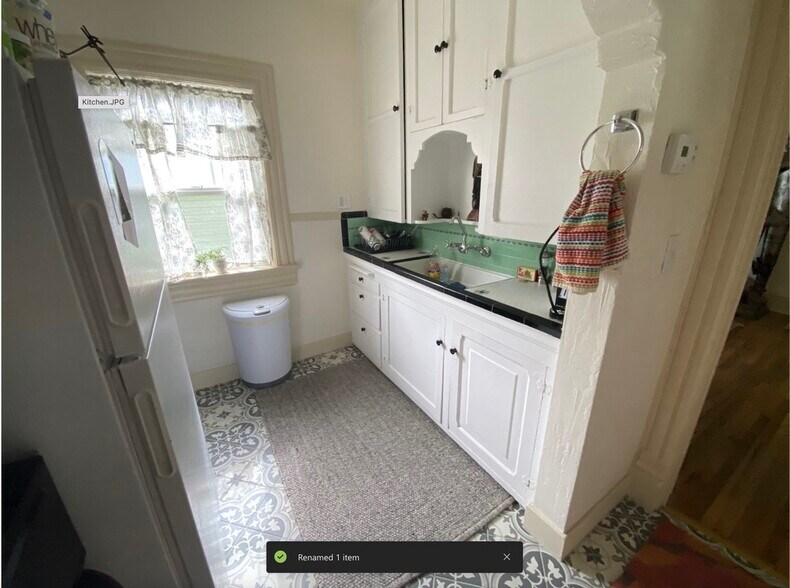 Kitchen is similar to this - antique tile and cabinets - 825 E 3rd Ave