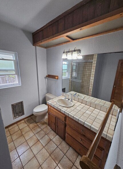 Natural wood vanity with Spanish Tile countertop & flooring. - 934 S Myers St