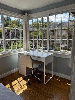 Desk, wheels, desk, chair, plus USB lamp in sunroom bedroom - 2615 Parker St