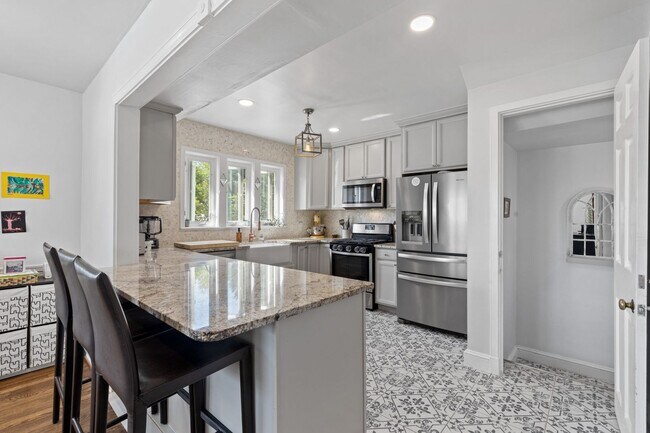 Building Photo - Luxurious Brick Colonial in Prestigious Gu...