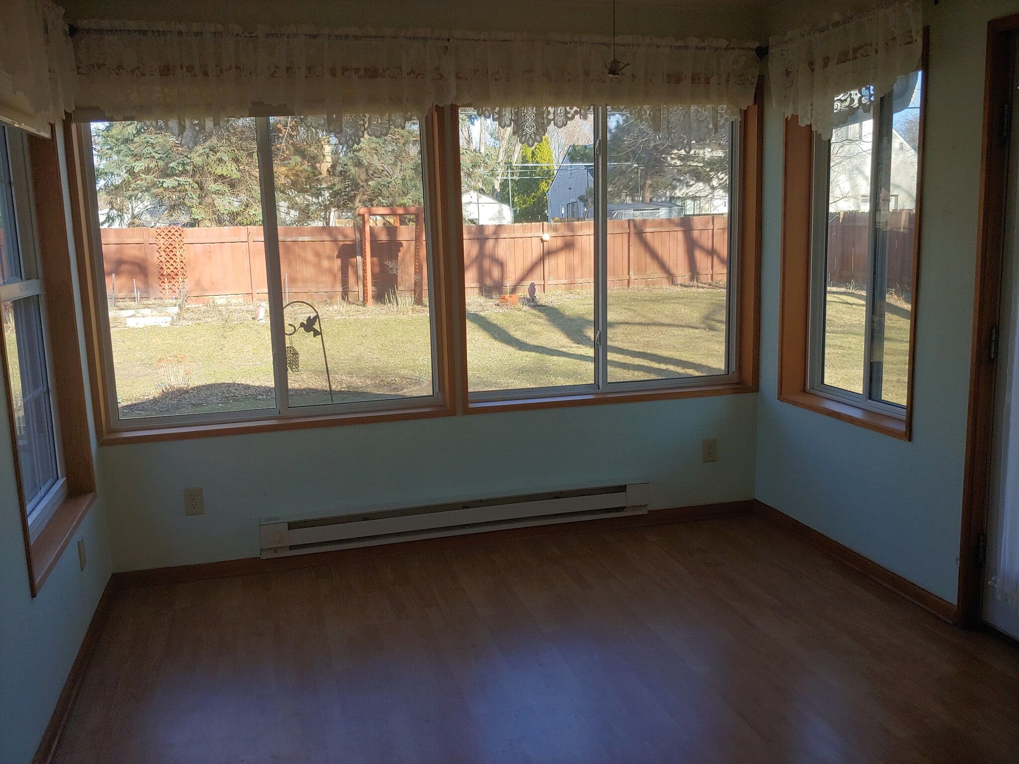 Sunroom, with windows facing expansive backyard and garden. - 7415 1st Ave S