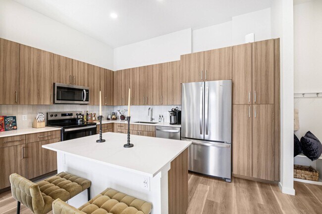 Quartz countertops with designer tile backsplashes at The Madison & The Fillmore - The Fillmore at Copperleaf