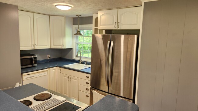 Kitchen with double-door stainless fridge and dishwasher - 703 Harding Ave