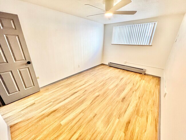 A blank canvas ready for personal touches, this bedroom offers style and comfort. - Melody Apartments