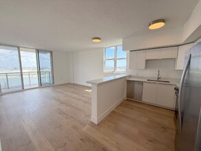 Building Photo - Rare 2/2 Corner Penthouse with Panoramic Lagoon Views from Every Room – Available Now!