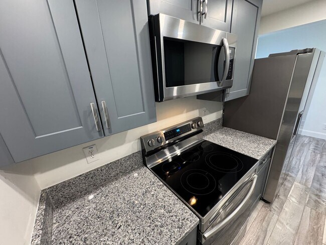 Building Photo - RENOVATED 3 bedroom end unit across the street from the Beach!