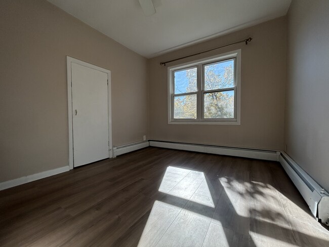 Bedroom 2 with brand new vinyl flooring. Enjoy the nature light! - 1231 Raymond Ave