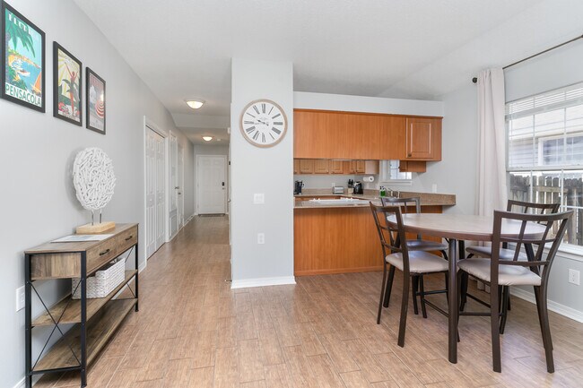 Open layout that let you see the kitchen and the living room with a dining table and 4 chairs. - 6464 Starfish Cv