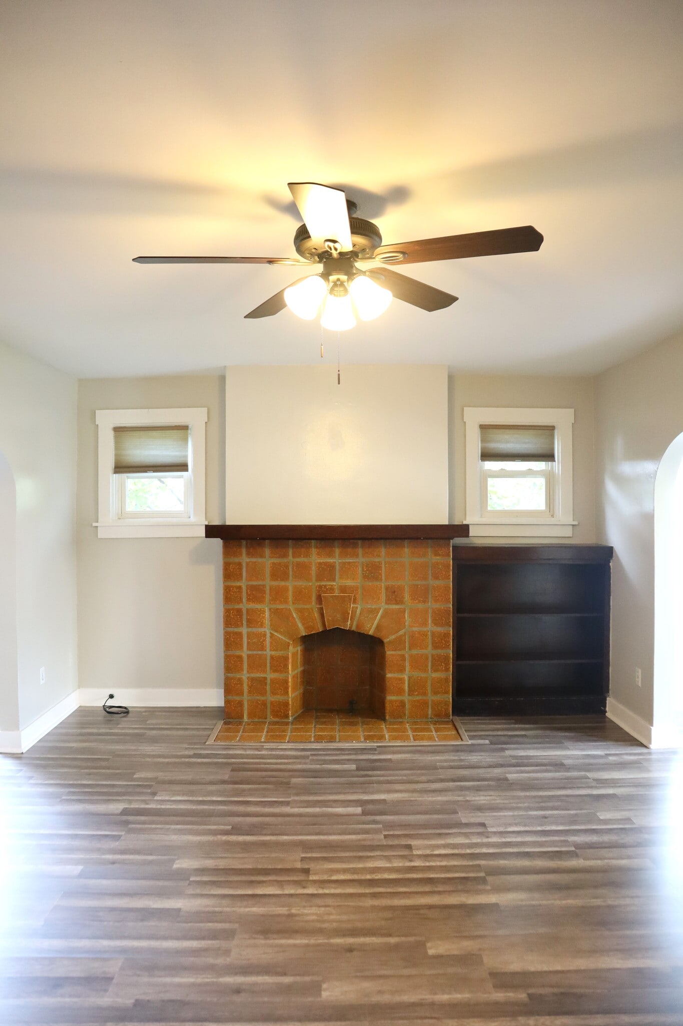 Spacious living room with new flooring and decorative fireplace. - 201 Richbarn Rd