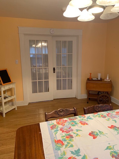 Dining table, french doors on the left to a bedroom or an office. - 704 W Cherokee Dr