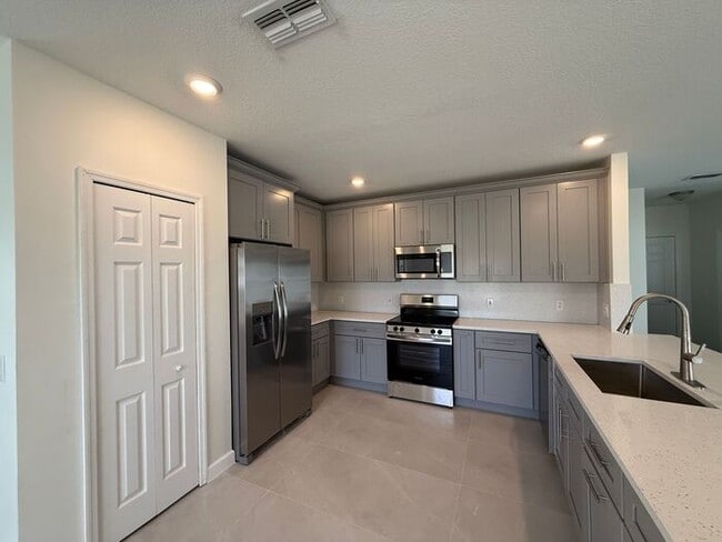 Building Photo - GORGEOUS, Large Completely Renovated Two-Story 4/2.5 PLUS LOFT in POINCIANA VILLAGES!