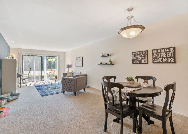 Spacious Living and Dining Area with natural light at Dover Hills Apartments Kalamazoo MI - Dover Hills Apartments