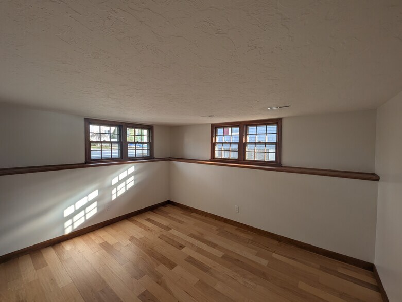 Warm natural wood features make this space ideal as a second bedroom office or den. - 24 Curtis St
