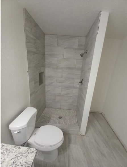 Close-up of shower with pebble-tile bottom. - 4720 Burma Rd