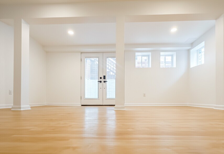 pacious multi-purpose room with fireplace and French doors (2025 addition) - 6471 Grommet Dr