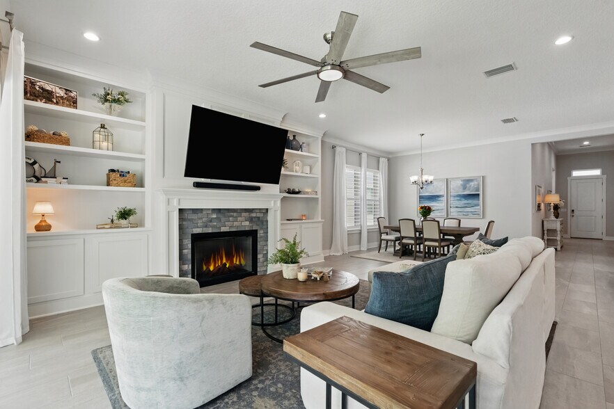 Open Living Room with fireplace and custom built-ins - 9918 Filament Blvd