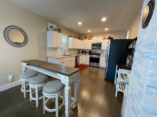 Bar seating and kitchen showing coffee bar. - 422 S Olive St