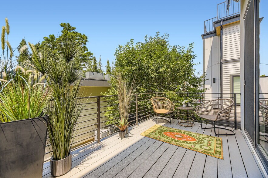 Kitchen and living room open to this shaded deck - 2765 S Sherman St