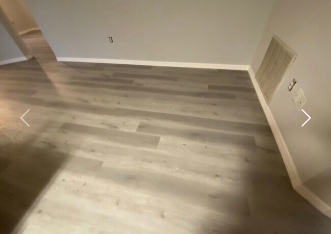 Building Photo - Available NOW! NEW FLOORS AND PAINT! Lovely 3/2 in Poinciana! HUGE fenced yard and NO CARPET!