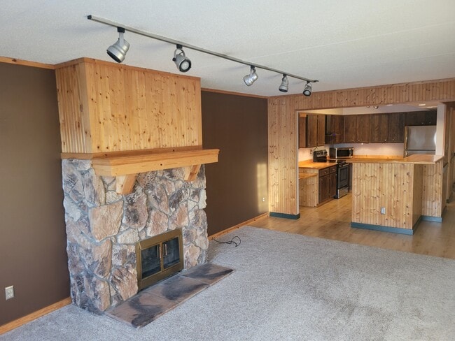 Rustic, cabin theme with open concept between spacious living room and kitchen - 3320 Louisiana Ave S