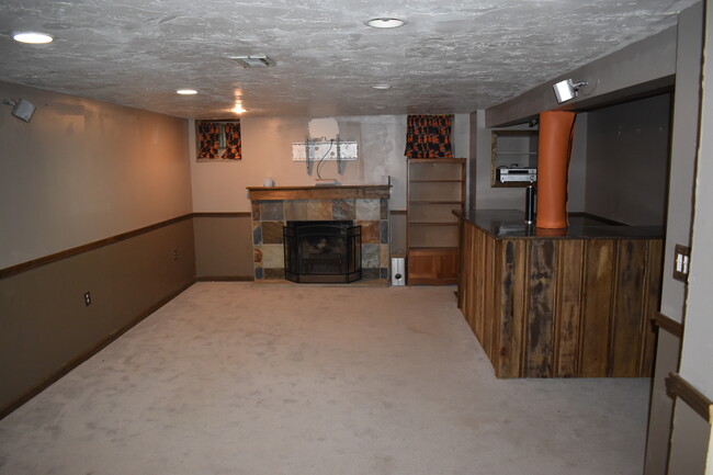 Finished basement with fireplace and bar - 18921 Coffinberry Blvd