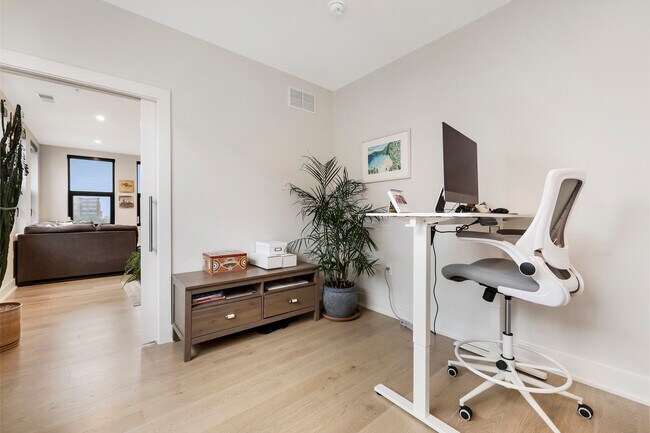 Den with pocket door, allowing for flexible space for office, nursery, or guest room - 701 Swann Ave