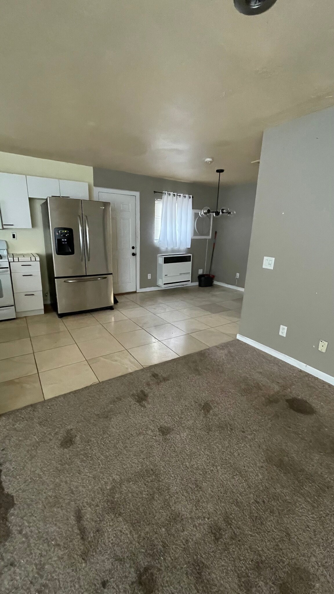 View of kitchen from living room. New carpeting will be installed before move-in date. - 13947 Meadow Ln