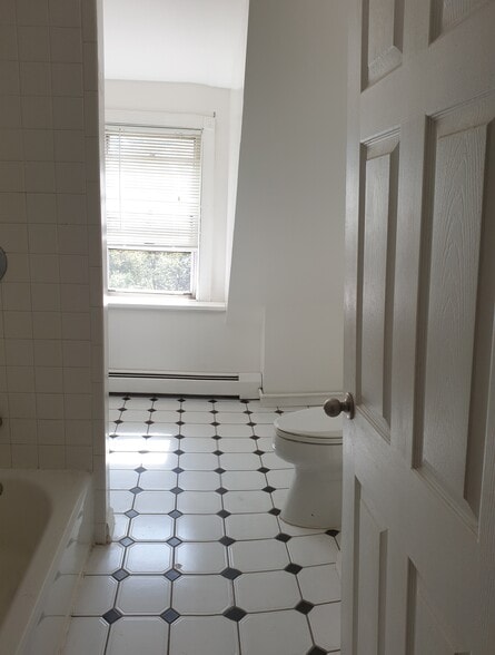 Bright, airy bathroom with natural light and a sophisticated black-and-white color palette - 412 Morris Ave