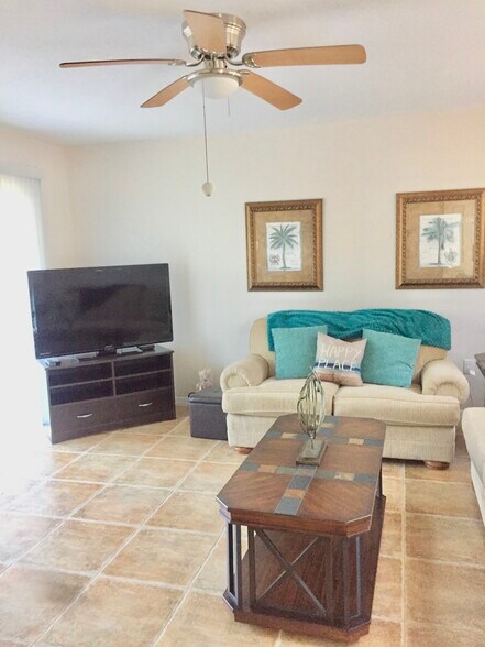 Living area. Ceiling fan. Sliding doors. - 7006 Midnight Pass Rd