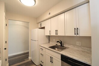 Building Photo - Fun and Stylish Living at Madison Manor! Top-Floor Condo with Vaulted Ceilings and Skylights
