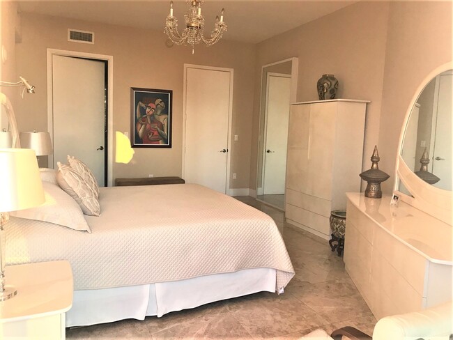 Master Bedroom with king size bed and crystal chandeliers. - 15901 Collins Ave