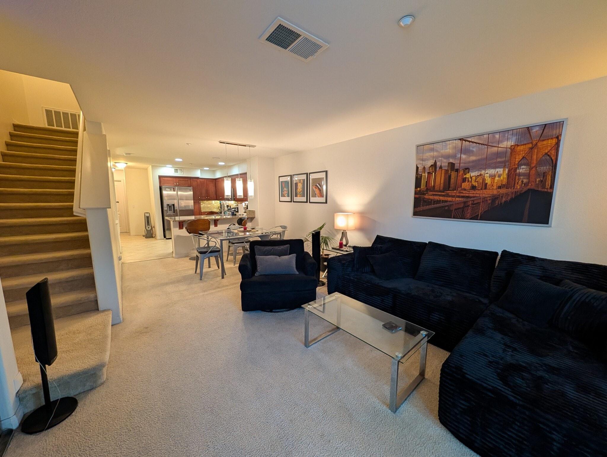 View from living room area facing towards dining and kitchen area. Stairs lead to 3rd floor bedrooms - 3542 Shoreline Bluff Lane
