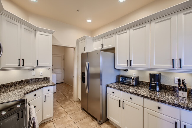 Kitchen with freshly updated cabinets and ample cooking supplies - 19475 N Grayhawk Dr