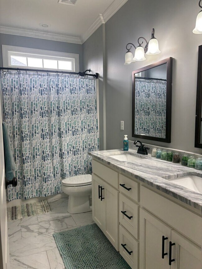 Building Photo - Spacious 4BR/3BA Creekside West Home with Screened Porch, Fenced Yard & 3-Car Garage