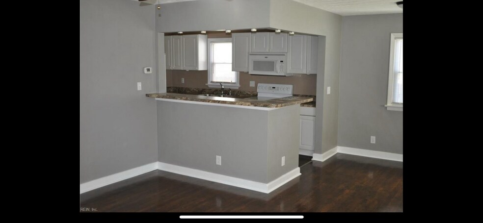 Older photo of living room/kitchen due to current tenants privacy - 8803 Chesapeake Blvd