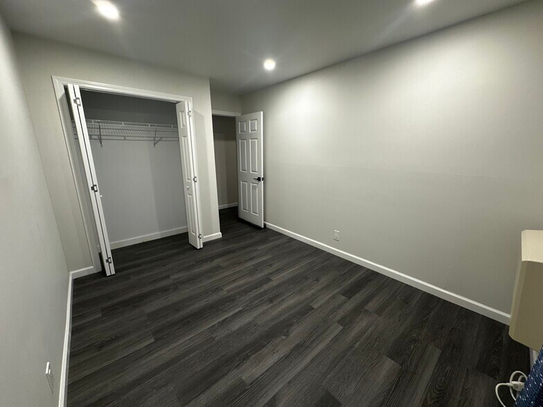 room with blue curtain + bigger closet with double bifold doors - 388 S Main St