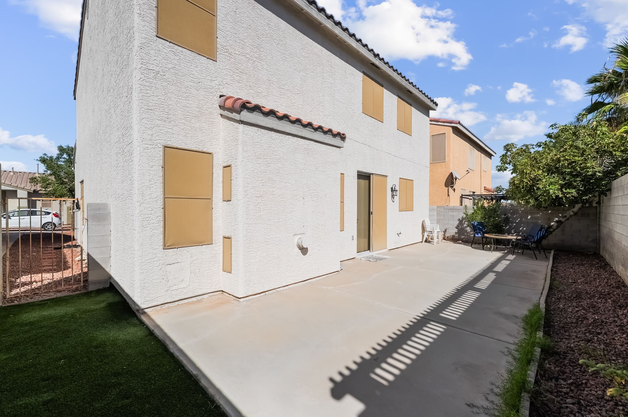 Back of property featuring a fenced backyard, a tile roof, a patio, and stucco siding - 1179 Antoinette St