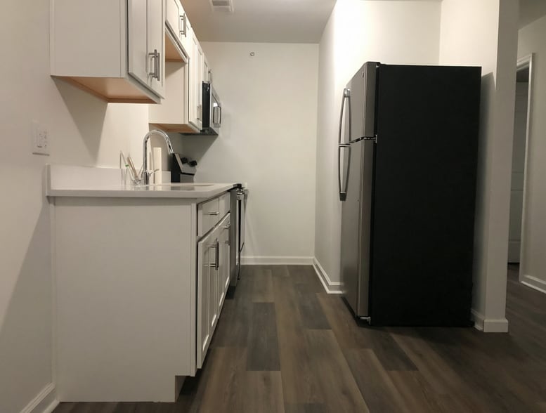 Renovated galley kitchen with new appliances. - 261 Simpson Ave