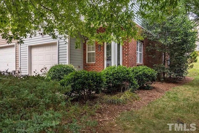 End unit front door with side yard and garage - 245 Plaza Dr
